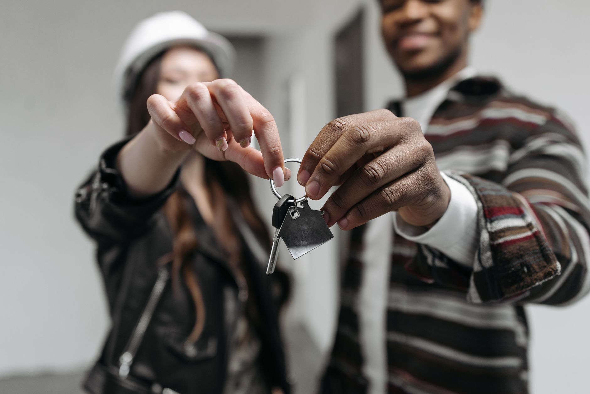 Couple holding new house keys, representative of a first-time Dholera buyer