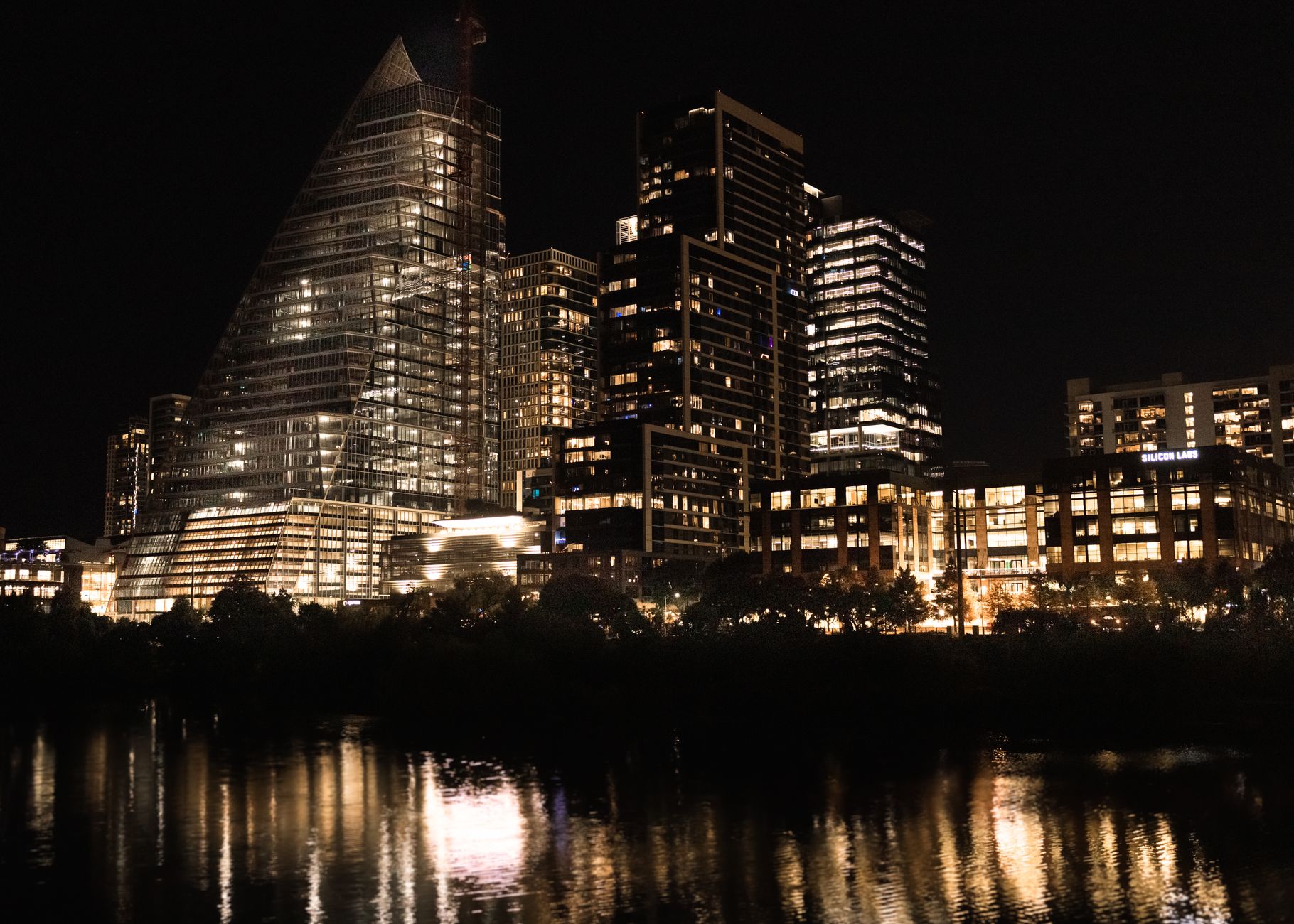 Illuminated modern city skyline at night, representative of a smart city